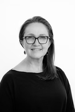 Rebecca Anderson, yoga and Bowen therapist at Serene Healing Therapies, smiling in a black and white portrait