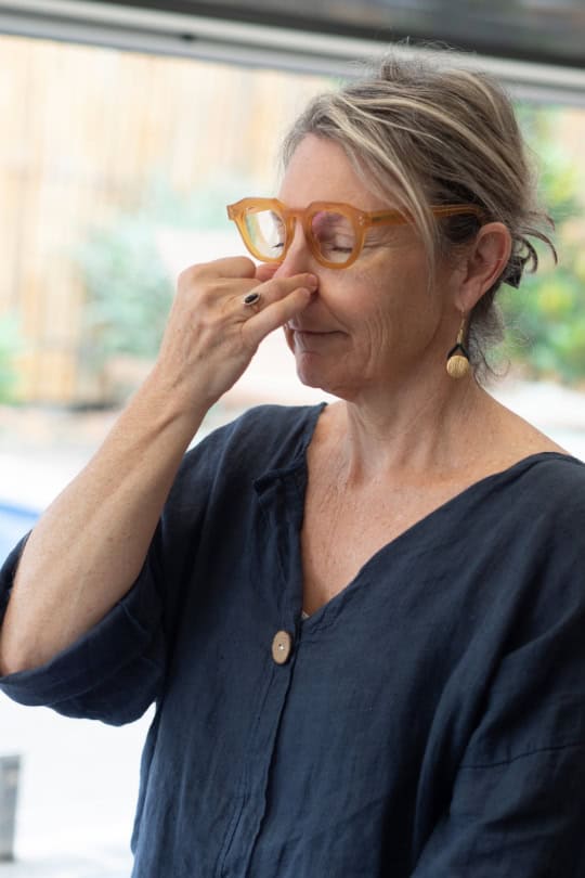 Showing woman practising alternate nostril breathing in yoga therapy